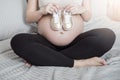 Beautiful asian pregnant woman expecting her baby with small shoes Royalty Free Stock Photo