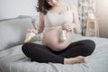 Beautiful asian pregnant woman expecting her baby with small shoes Royalty Free Stock Photo