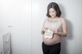 Beautiful asian pregnant woman expecting her baby with small socks Royalty Free Stock Photo