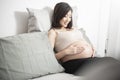 Beautiful asian pregnant woman lying on her bed, touching  big belly Royalty Free Stock Photo