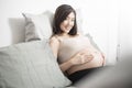 Beautiful asian pregnant woman lying on her bed, touching  big belly Royalty Free Stock Photo