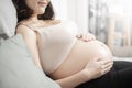 Beautiful asian pregnant woman lying on her bed, touching  big belly Royalty Free Stock Photo