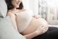 Beautiful asian pregnant woman lying on her bed, touching  big belly Royalty Free Stock Photo