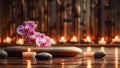 Spa composition with candles, orchid, massage hot stones and copy space Royalty Free Stock Photo