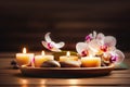 Beautiful asian spa still life with burning candles and orchids on wooden table Royalty Free Stock Photo