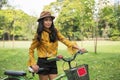 Bohemian girl hold bicycle in park