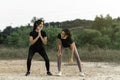 Beautiful asian teenagers doing exercise while wearing face mask