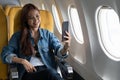 Beautiful asian travel woman take a selfie with mobile phone in airplane Royalty Free Stock Photo