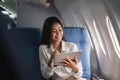Beautiful asian travel woman watching movie on digital tablet in airplane Royalty Free Stock Photo