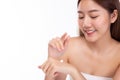 Beautiful asian woman apply body lotion or sunscreen lotion to hand for apply to face and body. Attractive beautiful asia girl has Royalty Free Stock Photo