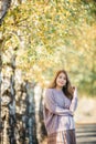 Beautiful asian woman with autumn leaves, flower and fall yellow leaves background at  Christchruch, New Zealand Royalty Free Stock Photo