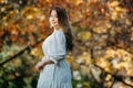 Beautiful asian woman with autumn leaves, flower and fall yellow leaves background at Hagley park, Christchruch, New Zealand Royalty Free Stock Photo