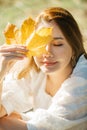 Beautiful asian woman with autumn leaves, flower and fall yellow leaves background at Hagley park, Christchruch, New Zealand Royalty Free Stock Photo