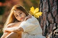 Beautiful asian woman with autumn leaves, flower and fall yellow leaves background at Hagley park, Christchruch, New Zealand Royalty Free Stock Photo