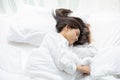Beautiful Asian woman basking and sleeping in white bed Royalty Free Stock Photo