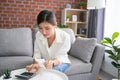 Beautiful Asian woman busy with financial paperwork. Monthly household budget management or expense planning. Bookkeeping concept Royalty Free Stock Photo