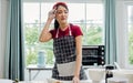 Beautiful Asian woman busy preparing equipment to make bread in weekend in comfortable indoor kitchen at home or bakery, getting