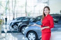 Beautiful Asian woman or car salesman Stand holding a new car remote key in the showroom, Cars For Sale Royalty Free Stock Photo