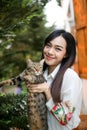 Beautiful asian woman carrying a cat on his hand with love,Cat lover concept