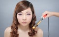 Beautiful asian woman curling hair