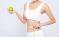 Beautiful asian woman diet and slim with measuring waist for weight and holding green apple fruit on white background Royalty Free Stock Photo