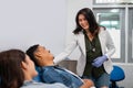 beautiful Asian woman doctor advising blood transfusion patient lying