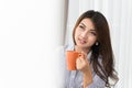 Beautiful asian woman drinking coffee at home Royalty Free Stock Photo