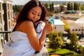 Beautiful Asian Woman Drinking Coffee In The Morning on the balcony. Royalty Free Stock Photo