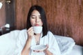 Beautiful asian woman drinking hot coffee at bedroom after wake up in the morning,Relax time,Free time,Healthy and lifestyle conce Royalty Free Stock Photo