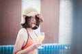 Beautiful Asian woman drinking orange juice at swimming pool,Happy and smiling,Relax time,Summer travel concept Royalty Free Stock Photo