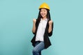 Beautiful Asian woman engineer developer hands up raised arms from happiness isolated on green background, Excited woman winner Royalty Free Stock Photo