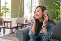 A beautiful asian woman enjoy listening to music with headphone Royalty Free Stock Photo