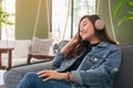 A beautiful asian woman enjoy listening to music with headphone Royalty Free Stock Photo