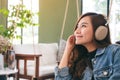 A beautiful asian woman enjoy listening to music with headphone Royalty Free Stock Photo
