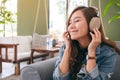 A beautiful asian woman enjoy listening to music with headphone Royalty Free Stock Photo