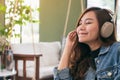 A beautiful asian woman enjoy listening to music with headphone Royalty Free Stock Photo