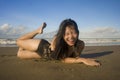 Beautiful Asian woman enjoying sand and sea - young happy and attractive Korean girl in bikini having fun at tropical beach during Royalty Free Stock Photo