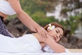 Beautiful asian woman enjoying spa massage therapy on the beach Royalty Free Stock Photo