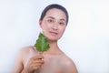 Beautiful asian woman face portrait with green leaf . Concept for skin care or organic cosmetics Royalty Free Stock Photo