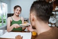 beautiful asian woman feeding her partner in the dining room Royalty Free Stock Photo