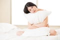 Beautiful asian woman feel sleepy and holding pillow in morning Royalty Free Stock Photo