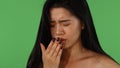 Beautiful Asian woman feeling sick and coughing on green chromakey