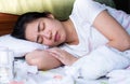 A beautiful asian woman getting sick and sleeping