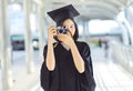 Beautiful Asian woman graduating holding her diploma and smiling Royalty Free Stock Photo