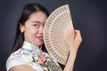 Beautiful Asian woman with a hand fan Royalty Free Stock Photo