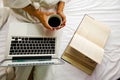 Beautiful asian woman hand holding a cup of coffee on the bed