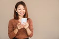 Beautiful Asian woman hand holding smart phone with happy face browsing internet , technology with people Royalty Free Stock Photo