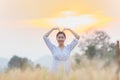 Beautiful asian woman having fun at barley field in summer at sunset time Royalty Free Stock Photo