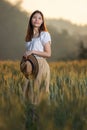 Beautiful asian woman having fun at barley field in summer at sunset time Royalty Free Stock Photo