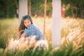 Beautiful Asian woman having relax time on a swing in nature field for nature hapiness lifestyle